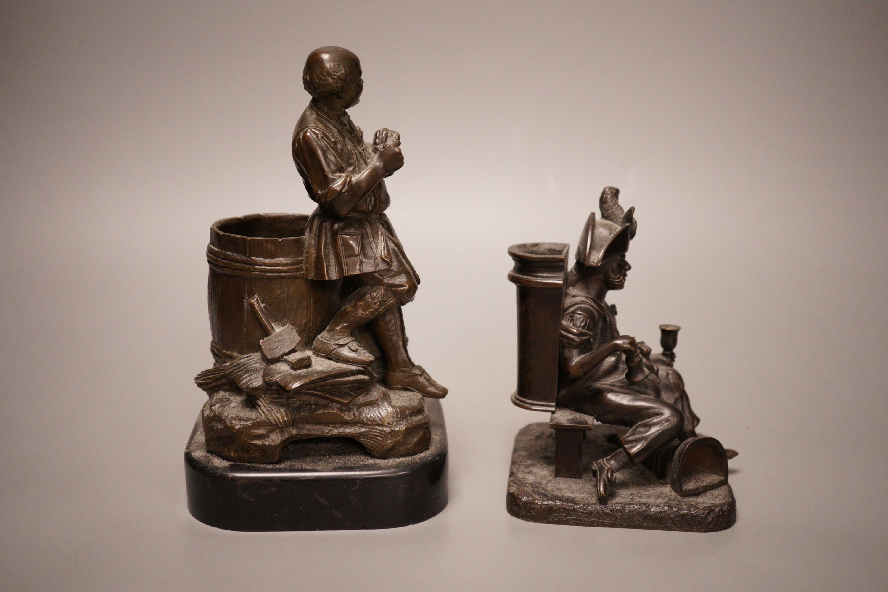 Two late 19th century bronze spill vases, cast as a tradesman and a war veteran. Tallest 19cm